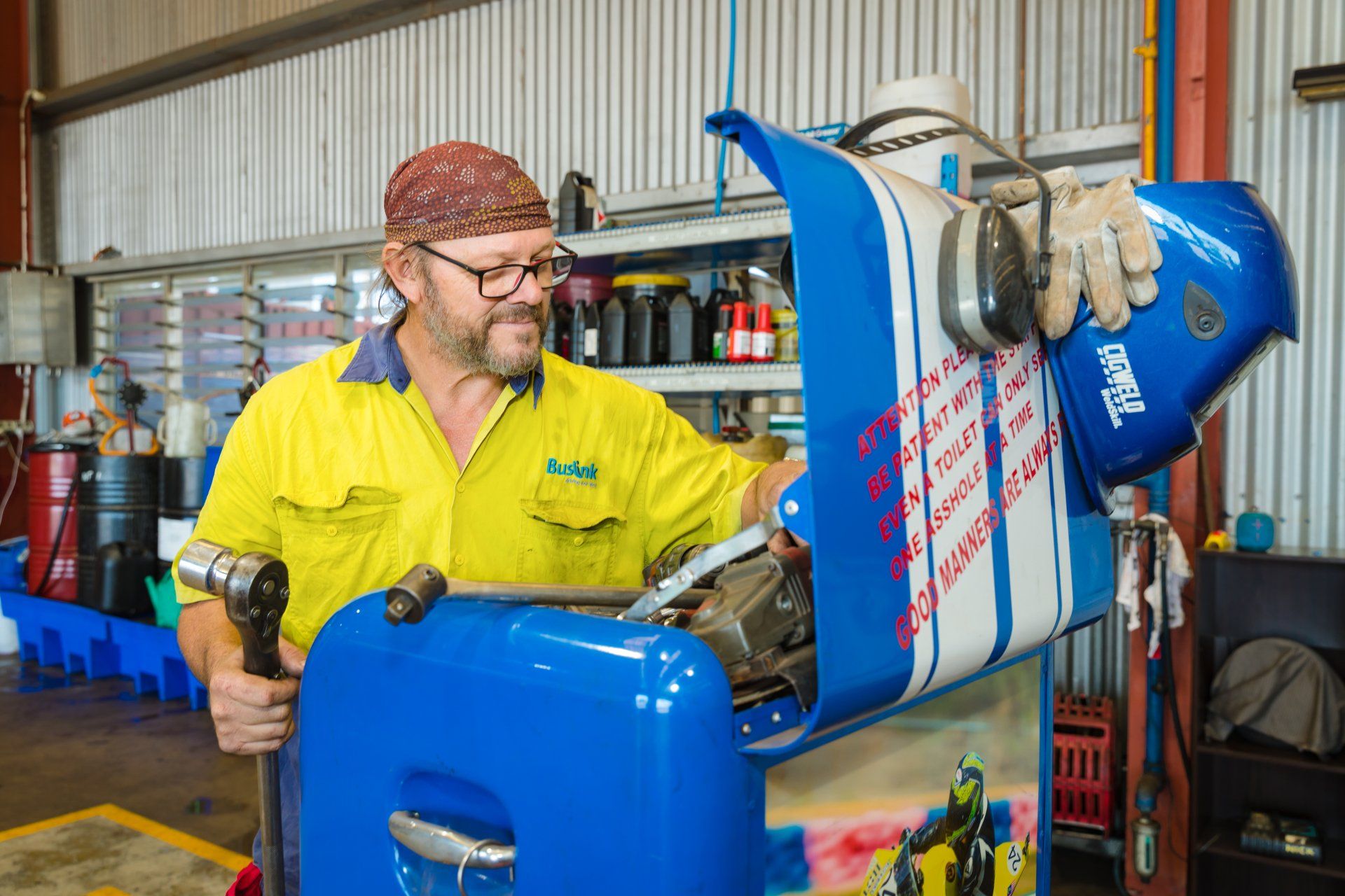 A man is working on a machine in a garage.