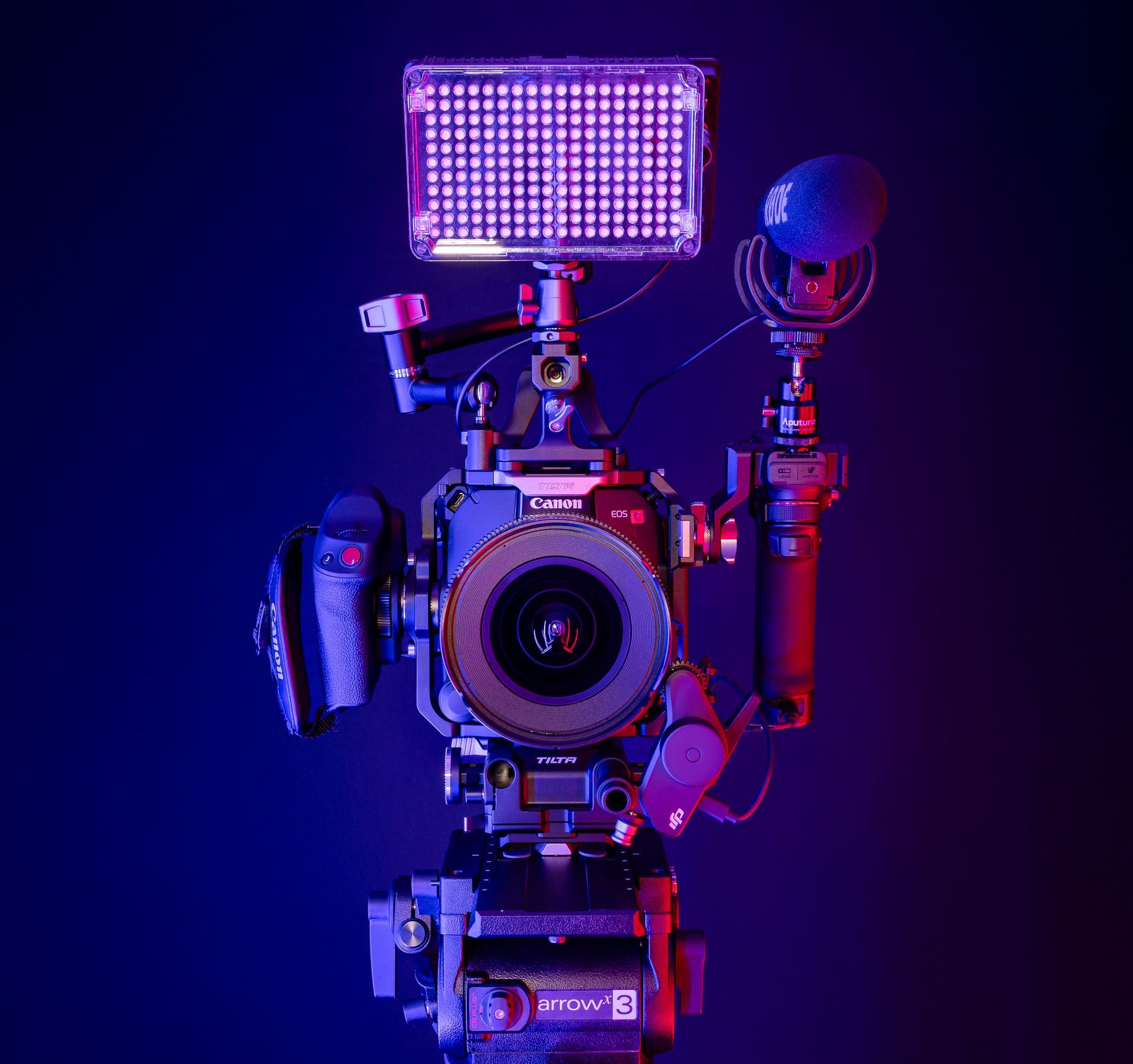 A man is taking a picture of a sunset over a lake.