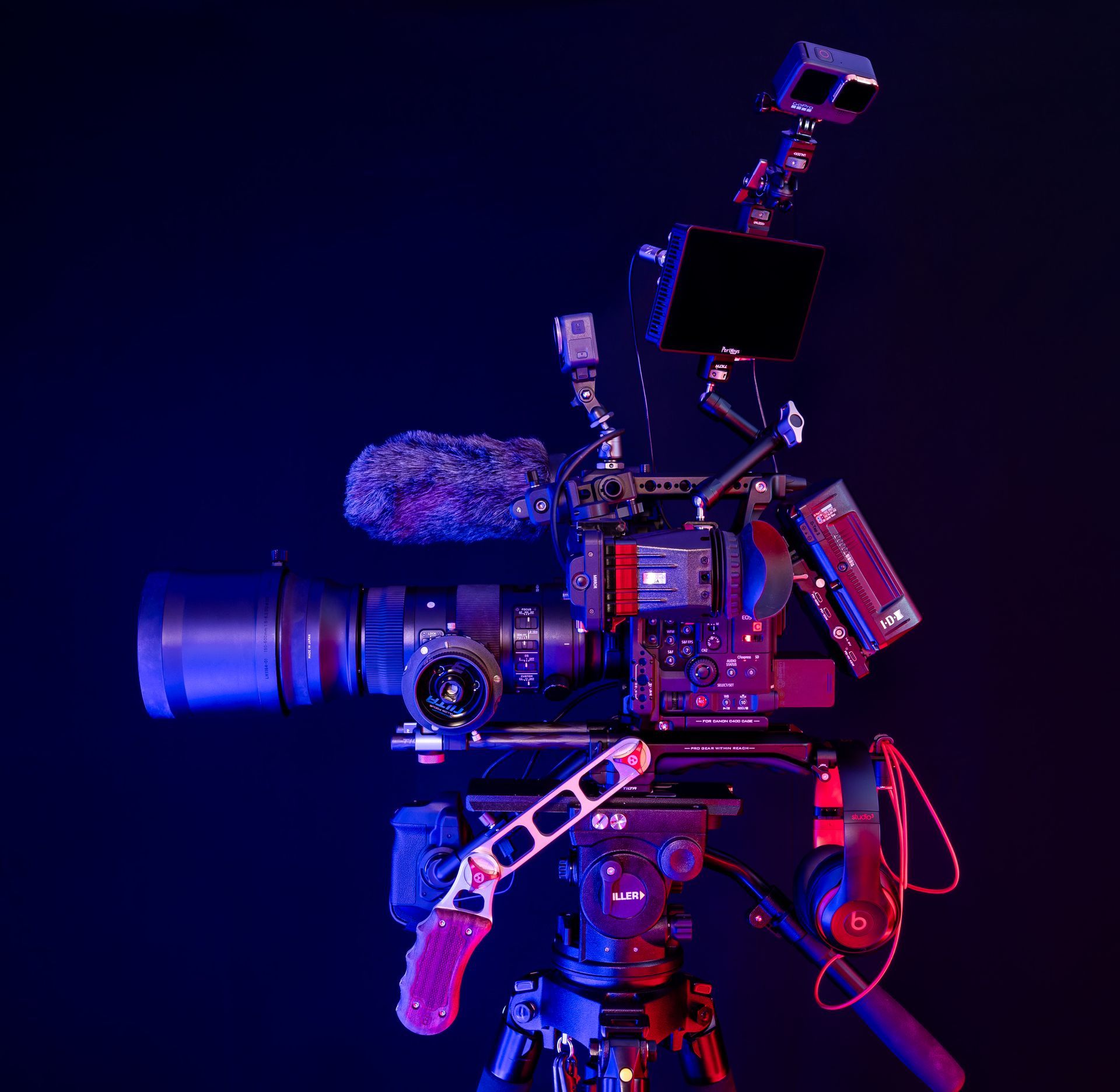 A man is taking a picture of a sunset over a lake.