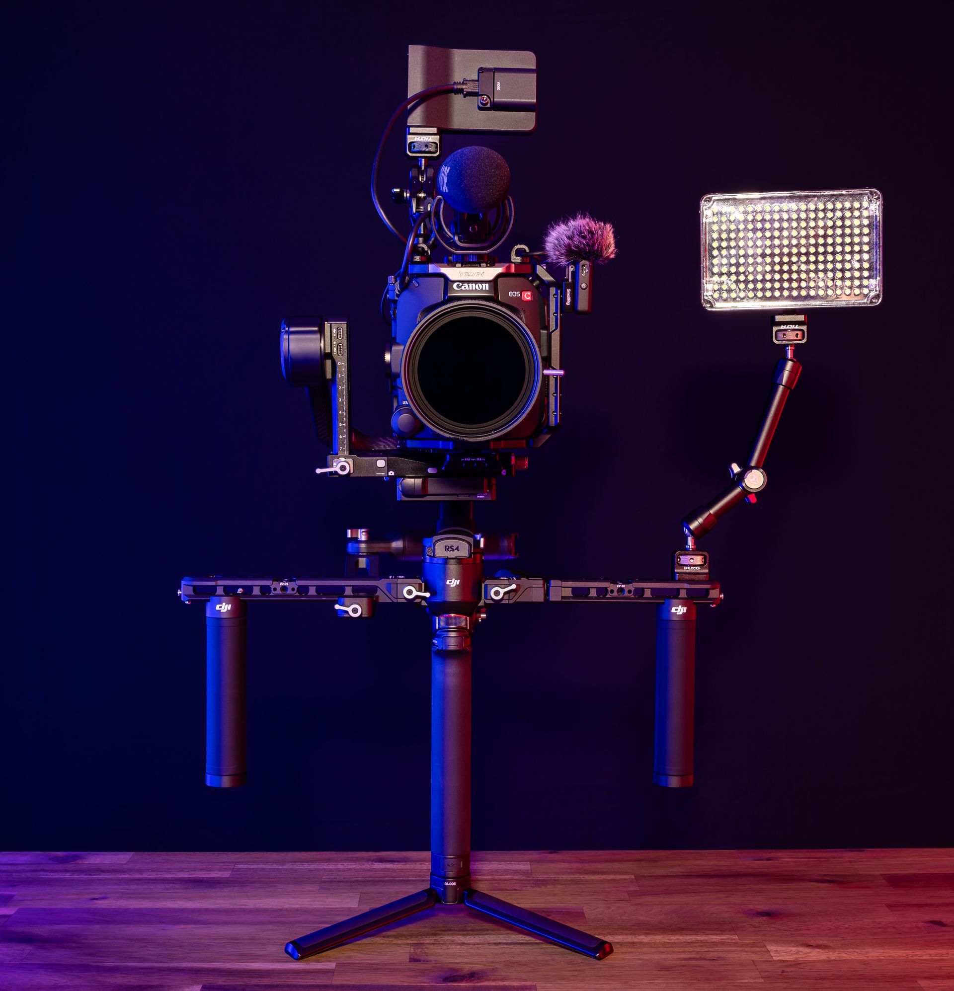 A man is taking a picture of a sunset over a lake.