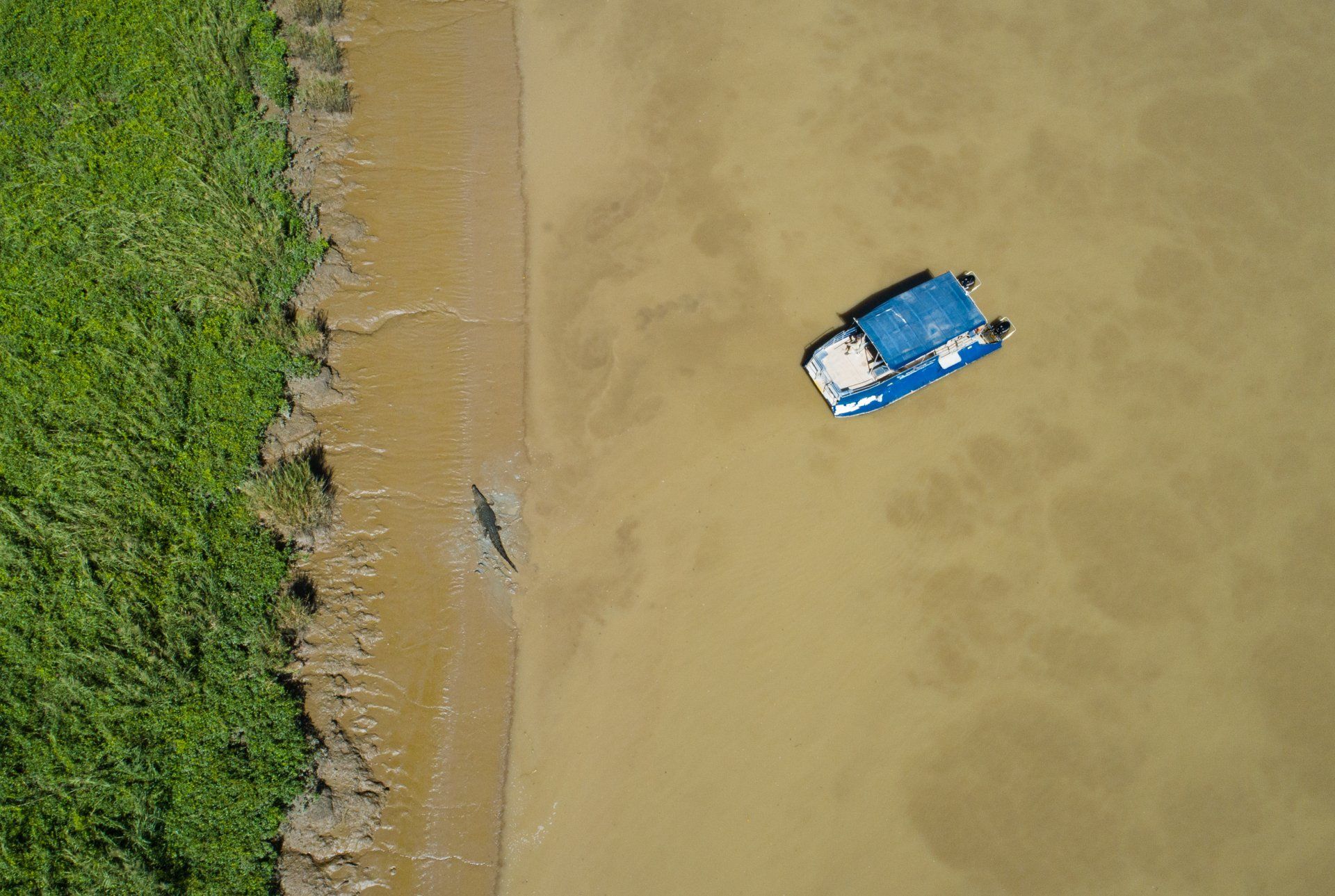 An aerial view of a boat floating on top of a body of water.