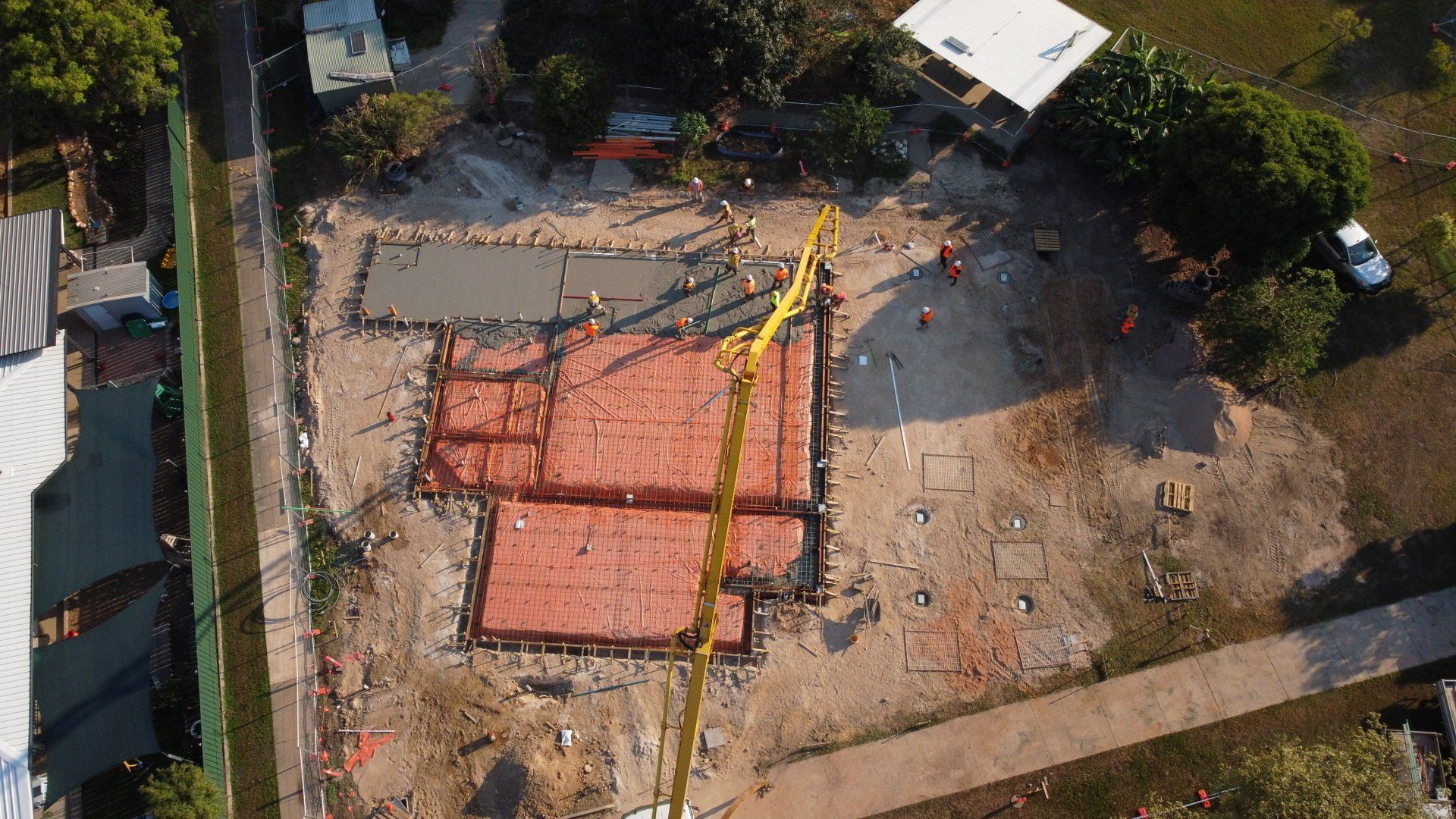 An aerial view of a construction site with a crane.