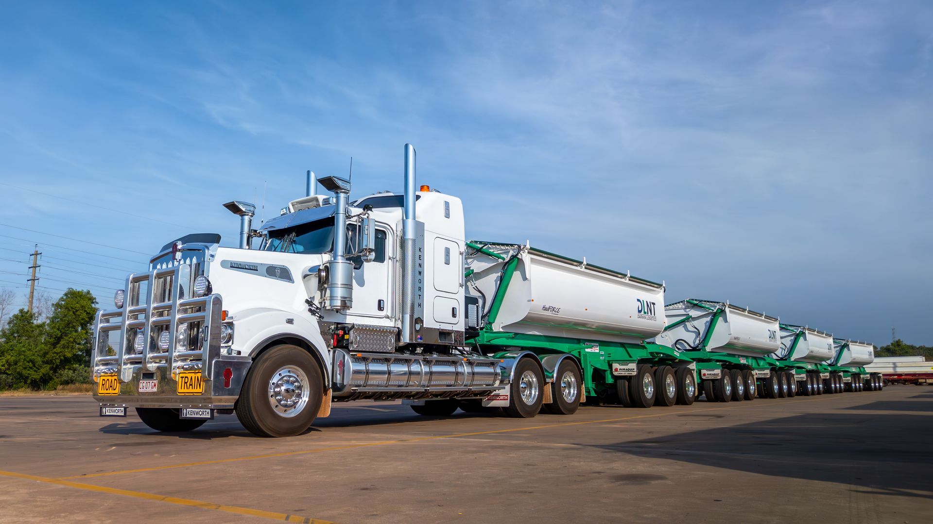 A red car with the hood up is parked on the side of the road.
