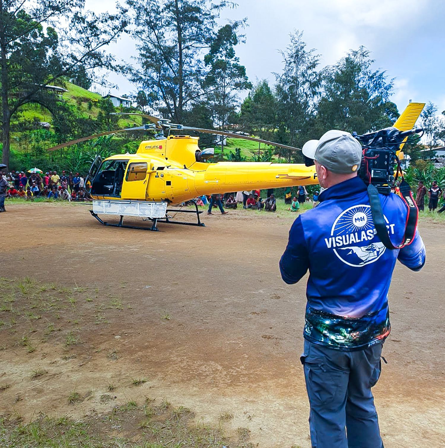 A red car with the hood up is parked on the side of the road.