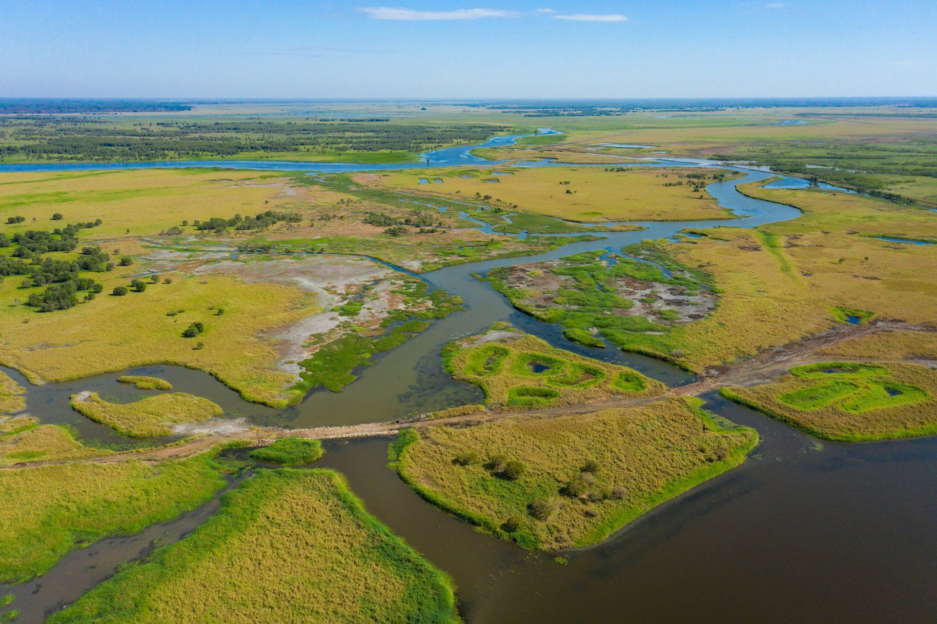 An aerial view of a swamp with a river running through it.