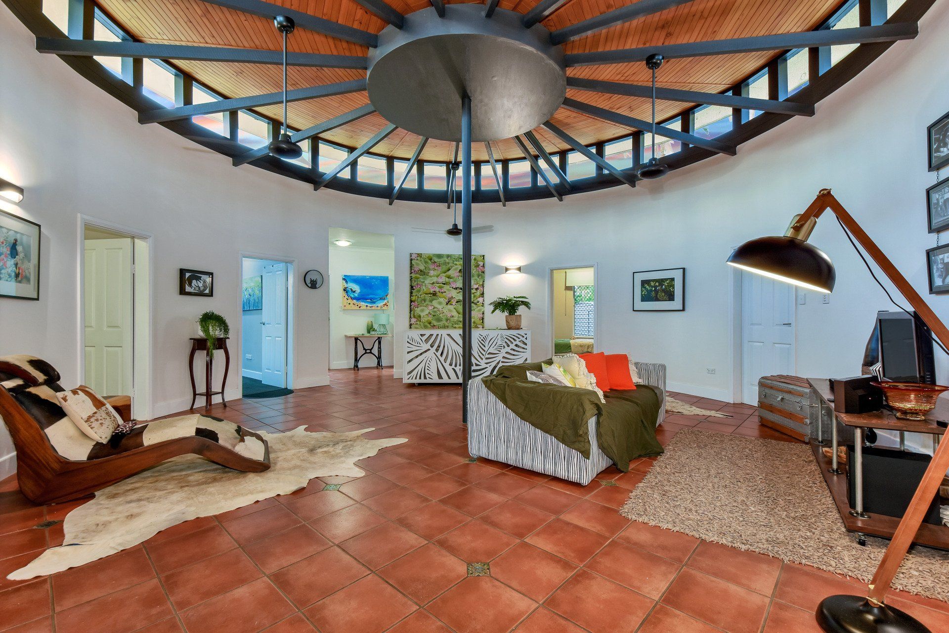 A living room with a circular ceiling and a couch.