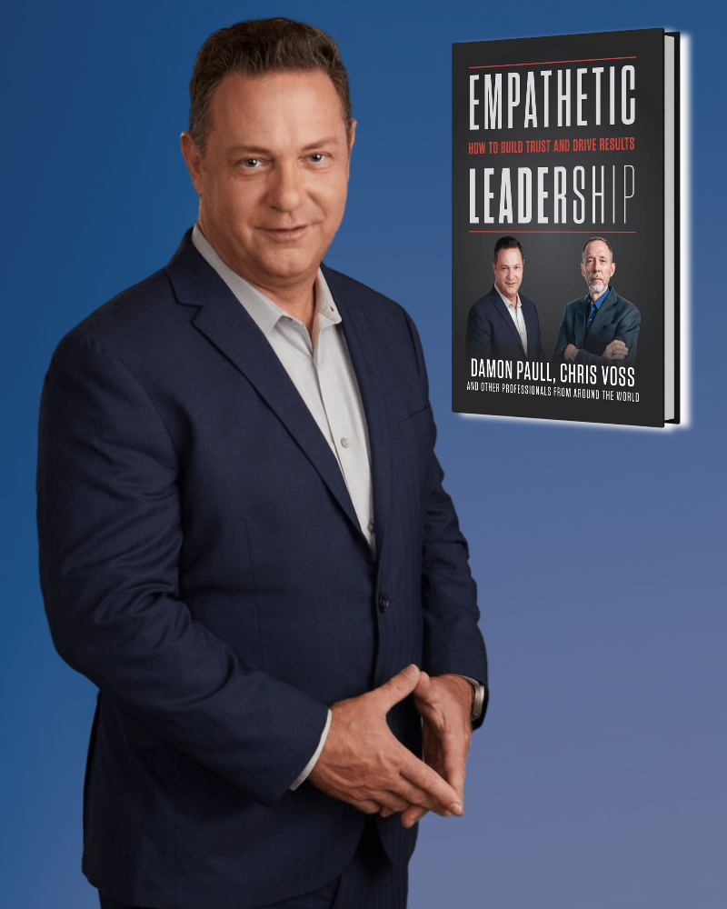 Man in a suit next to his book 