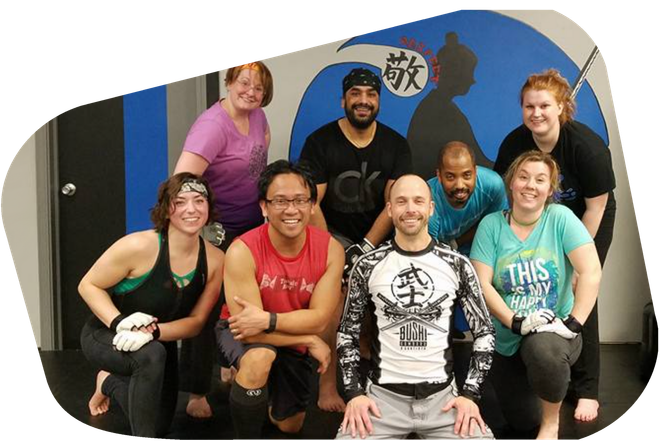 A group of people are posing for a picture in a gym.