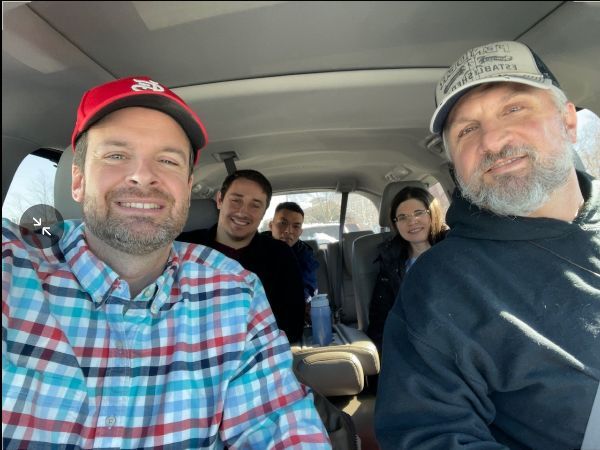 A group of people are posing for a picture in a car