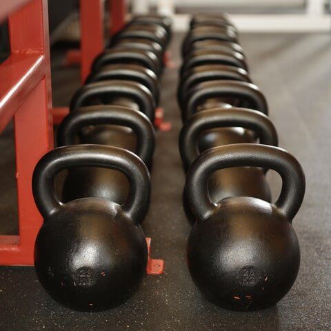 A Row Of Kettlebells Are Lined Up In A Gym — 360 Fitness Group in Cairns, QLD