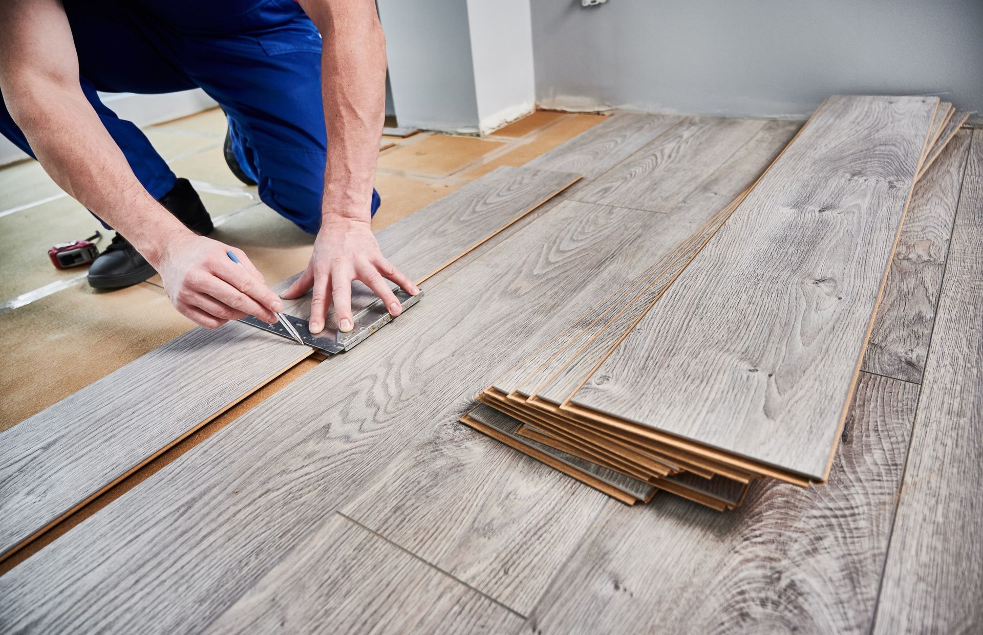 Man installing hardwood flooring.