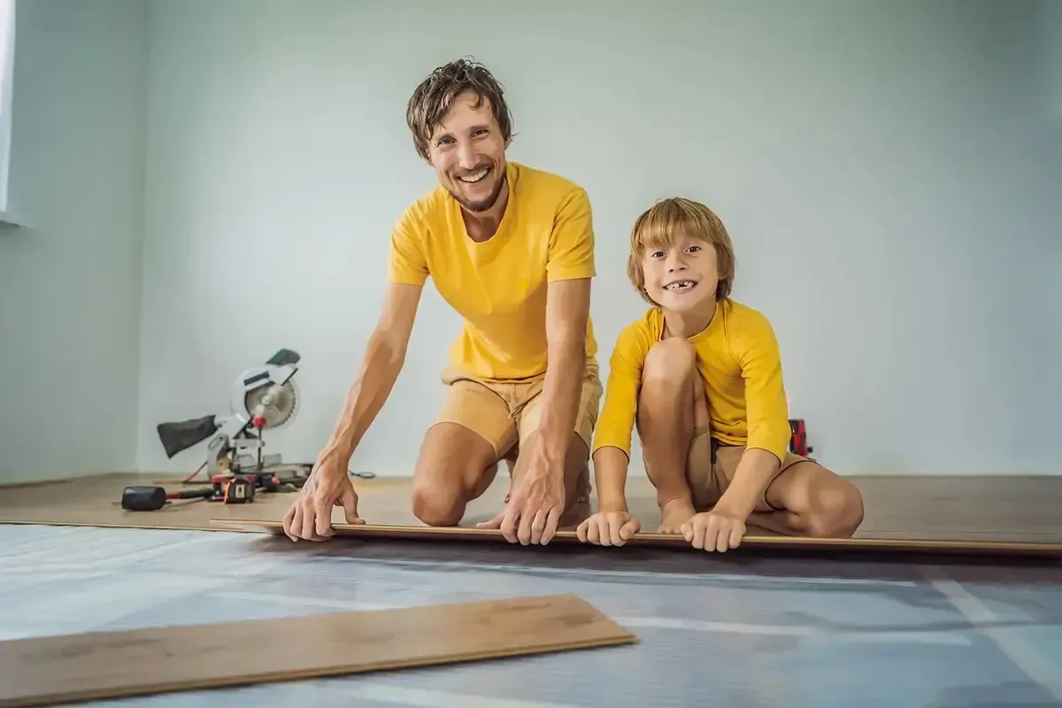 Father and son installing audacity flooring.