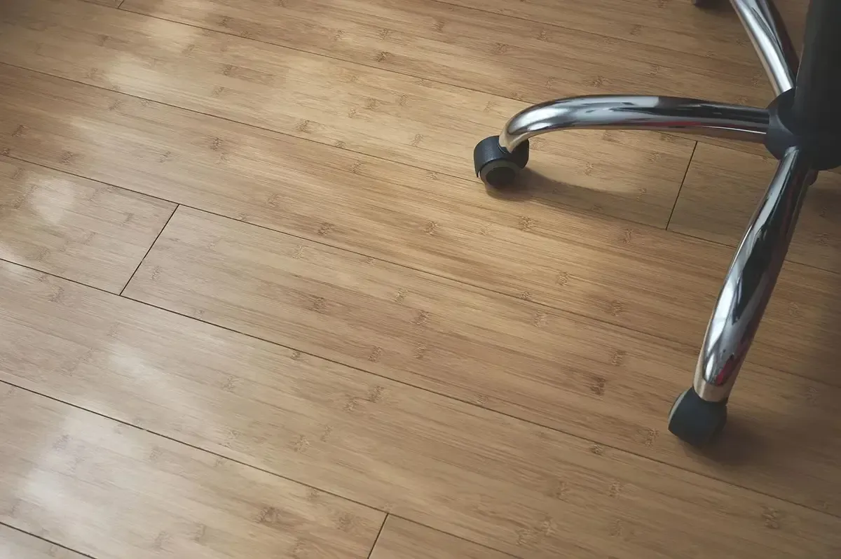 Bamboo flooring with a rolling office chair.