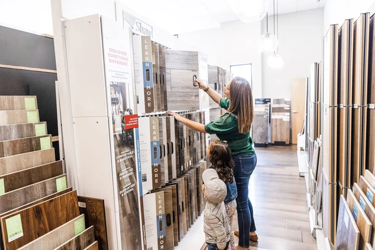 Woman looking at the best laminate flooring brands.