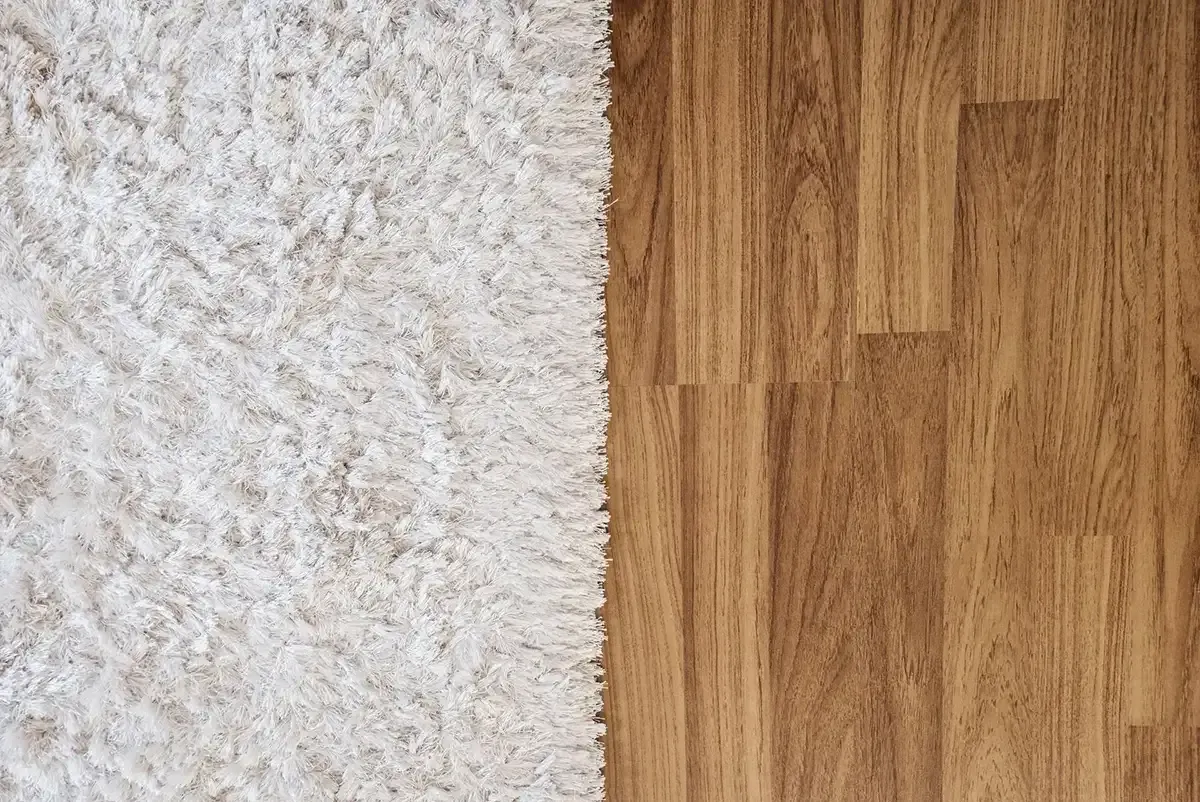 Side-by-side comparison of hardwood and carpet flooring.