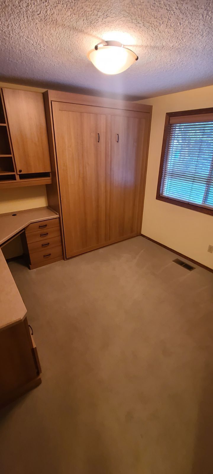 Preparing the kitchen floor for laminate installation.