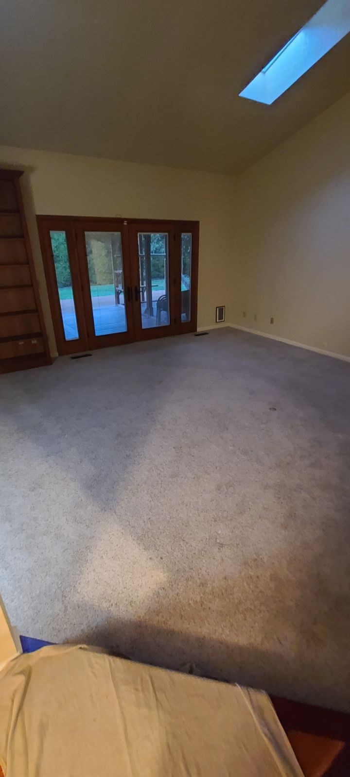 Carpeted living room before Crestwood flooring installation.