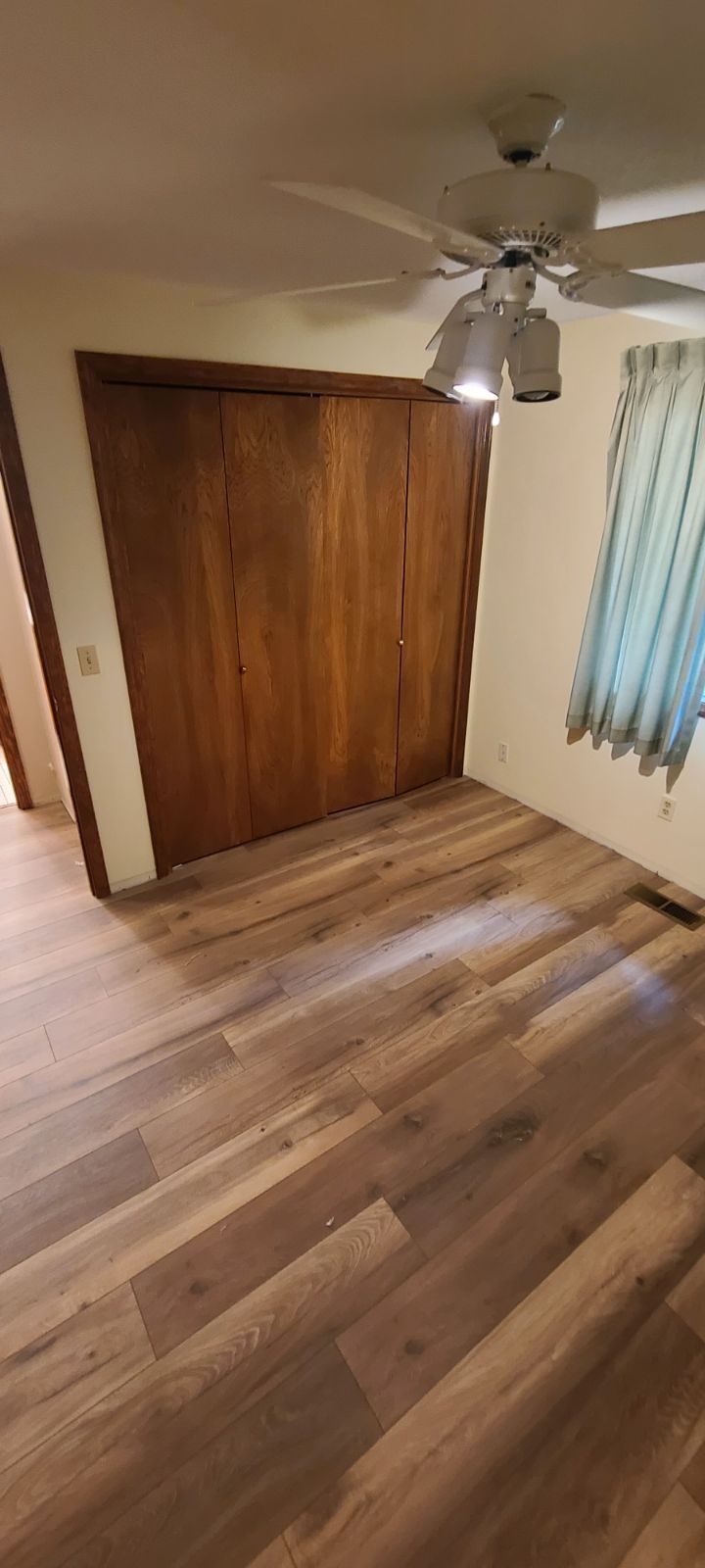 New laminate floor installed in small room.