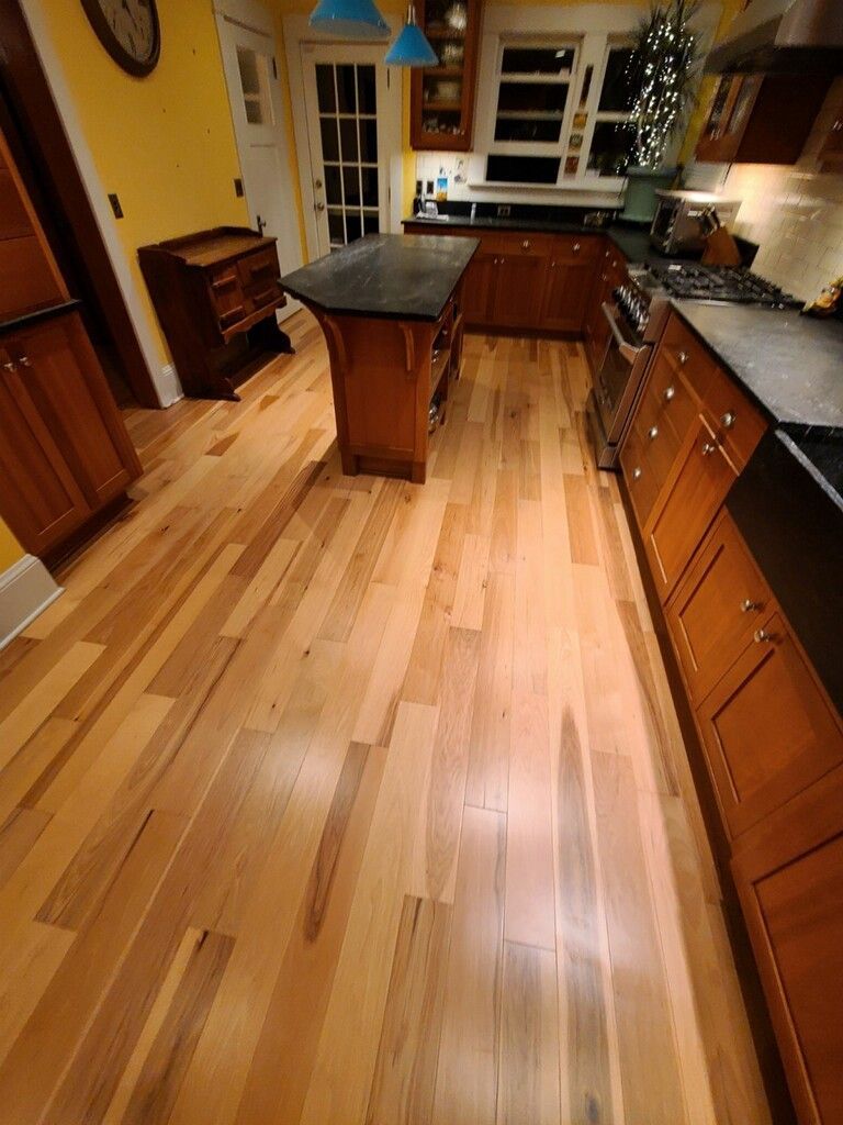 Another angle of new Hallmark Floors Natural Hickory installed in a kitchen.
