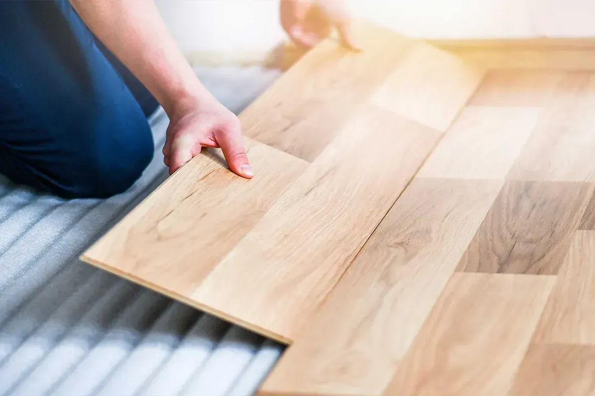 Man installing laminate flooring.