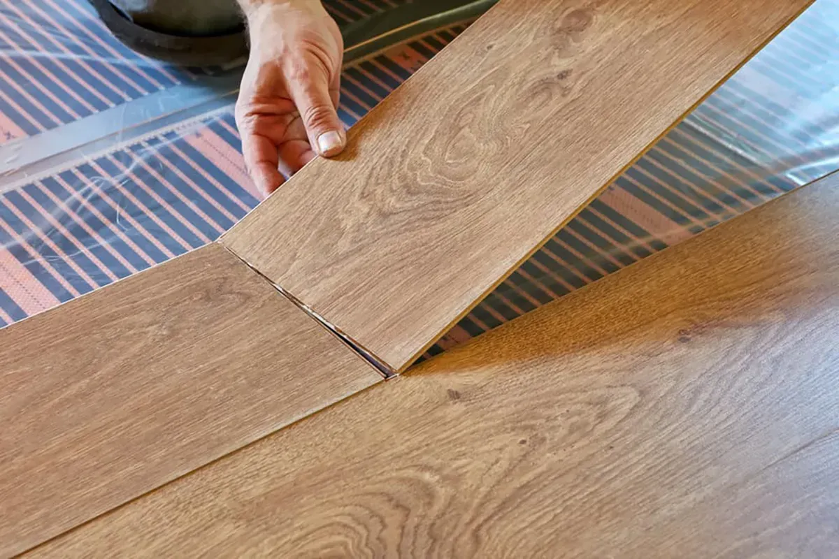 Close up of laminate flooring being installed.