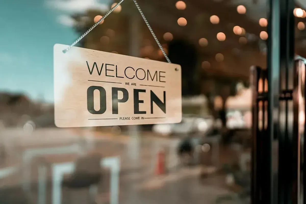 Open sign on the door of a local flooring store.