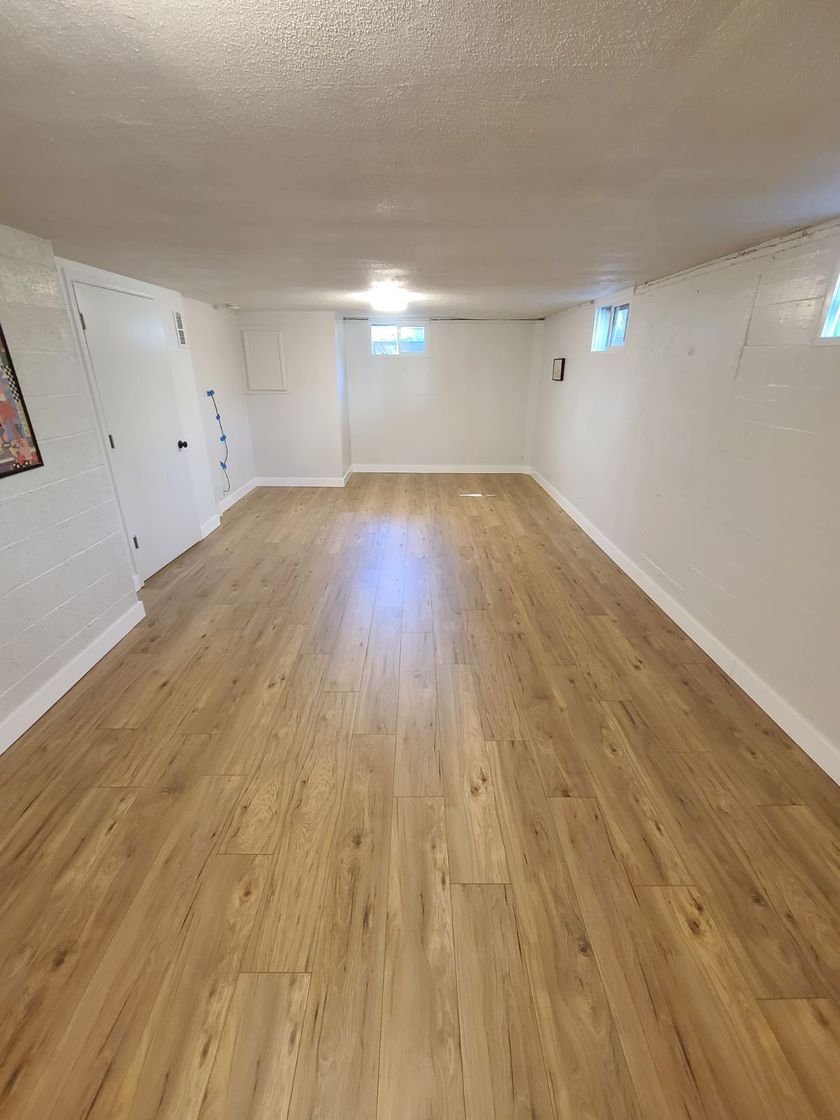 Finished basement laminate flooring installation in Portland, Oregon.