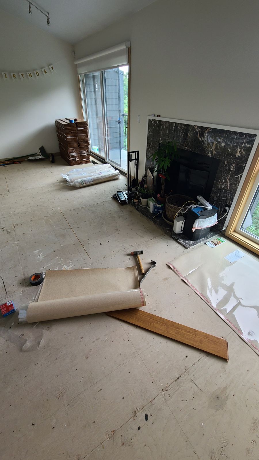 Floating bamboo flooring installation in bedroom.