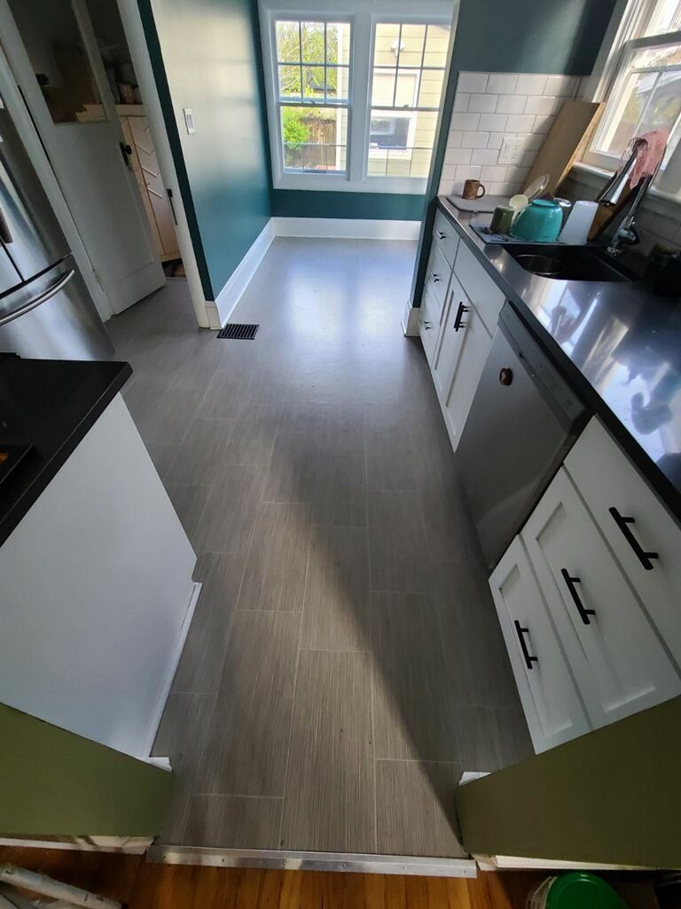 Old flooring in the kitchen before switching to cork.