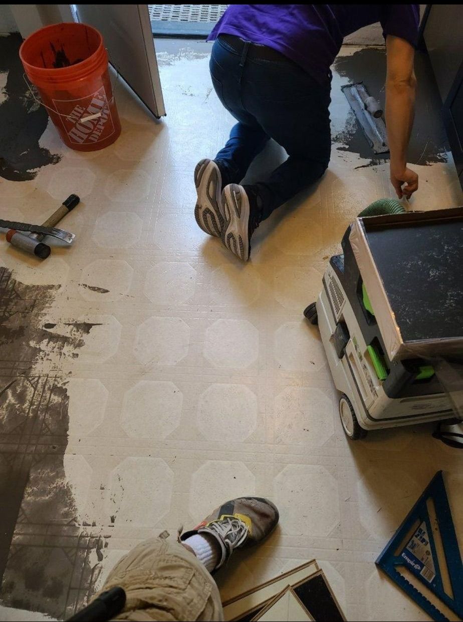 Preparing kitchen floor for Marmoleum Cinch Loc Seal installation.