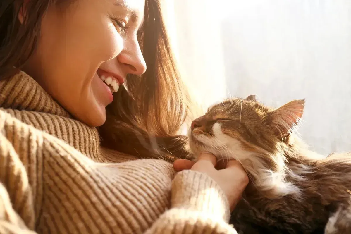 Woman holding a cat.