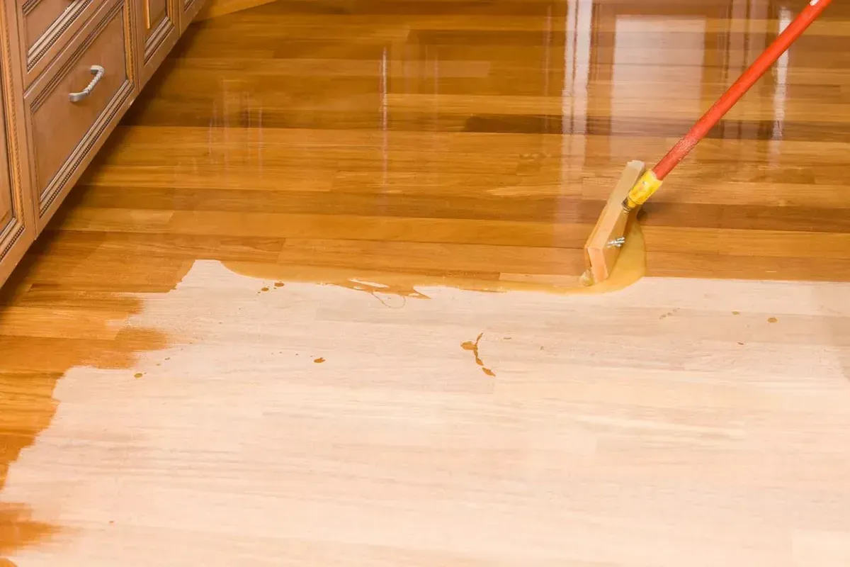 Refinishing dark hardwood floors to light.