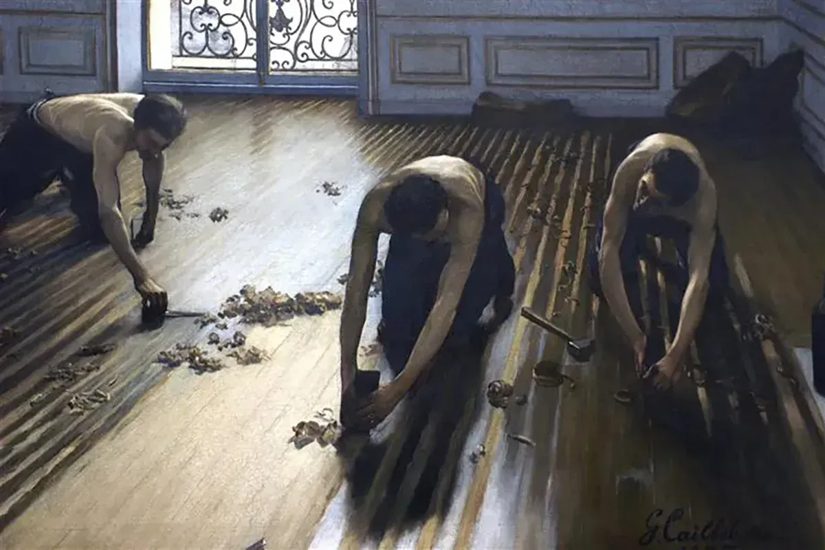 3 men stripping finish from a hardwood floor.