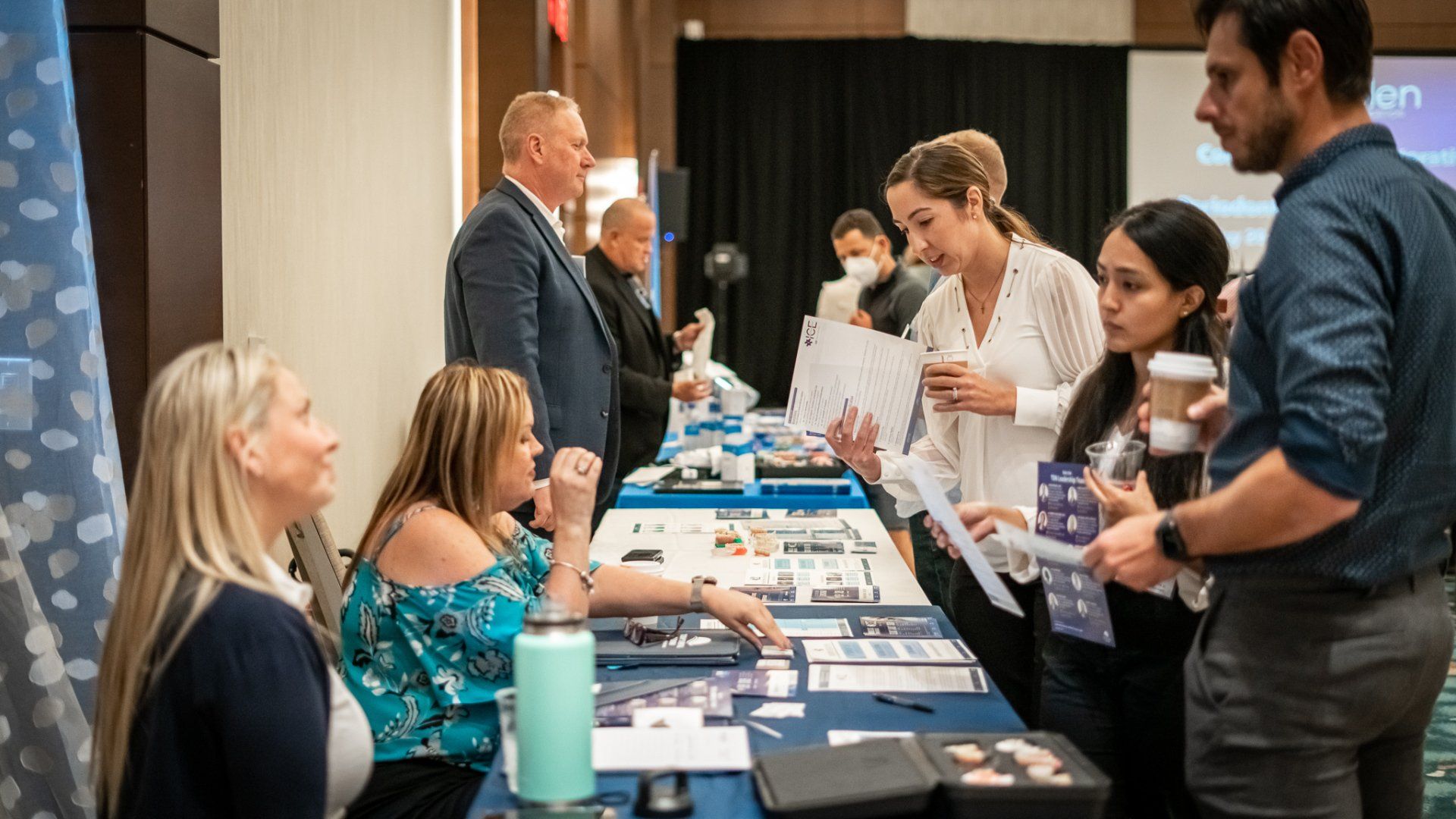 A group of people are sitting at a table at a job fair.