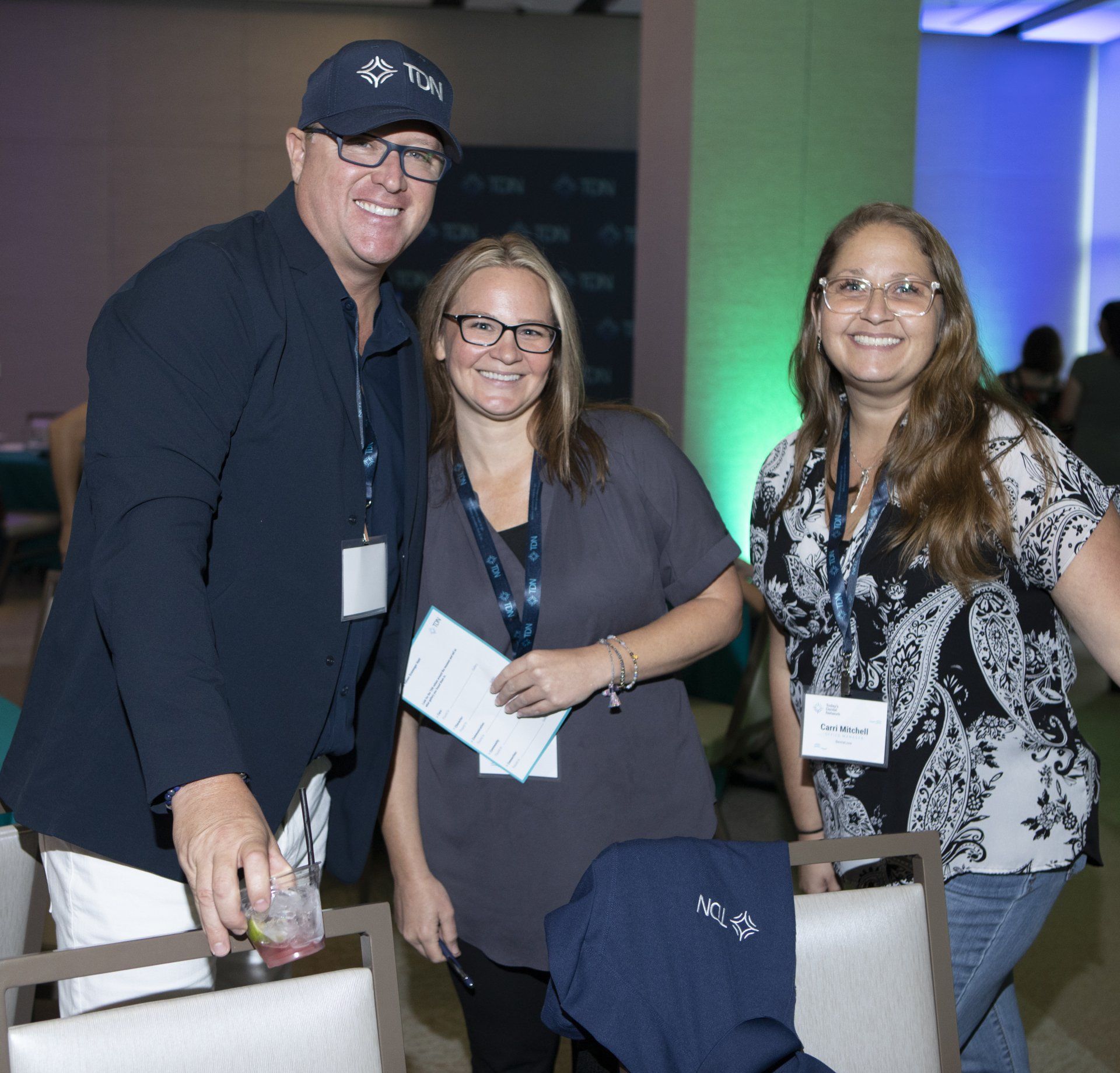 A man and two women are posing for a picture together
