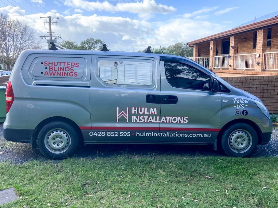 A Silver Van Is Parked In Front Of A House — Solis Signs in Toukley, NSW