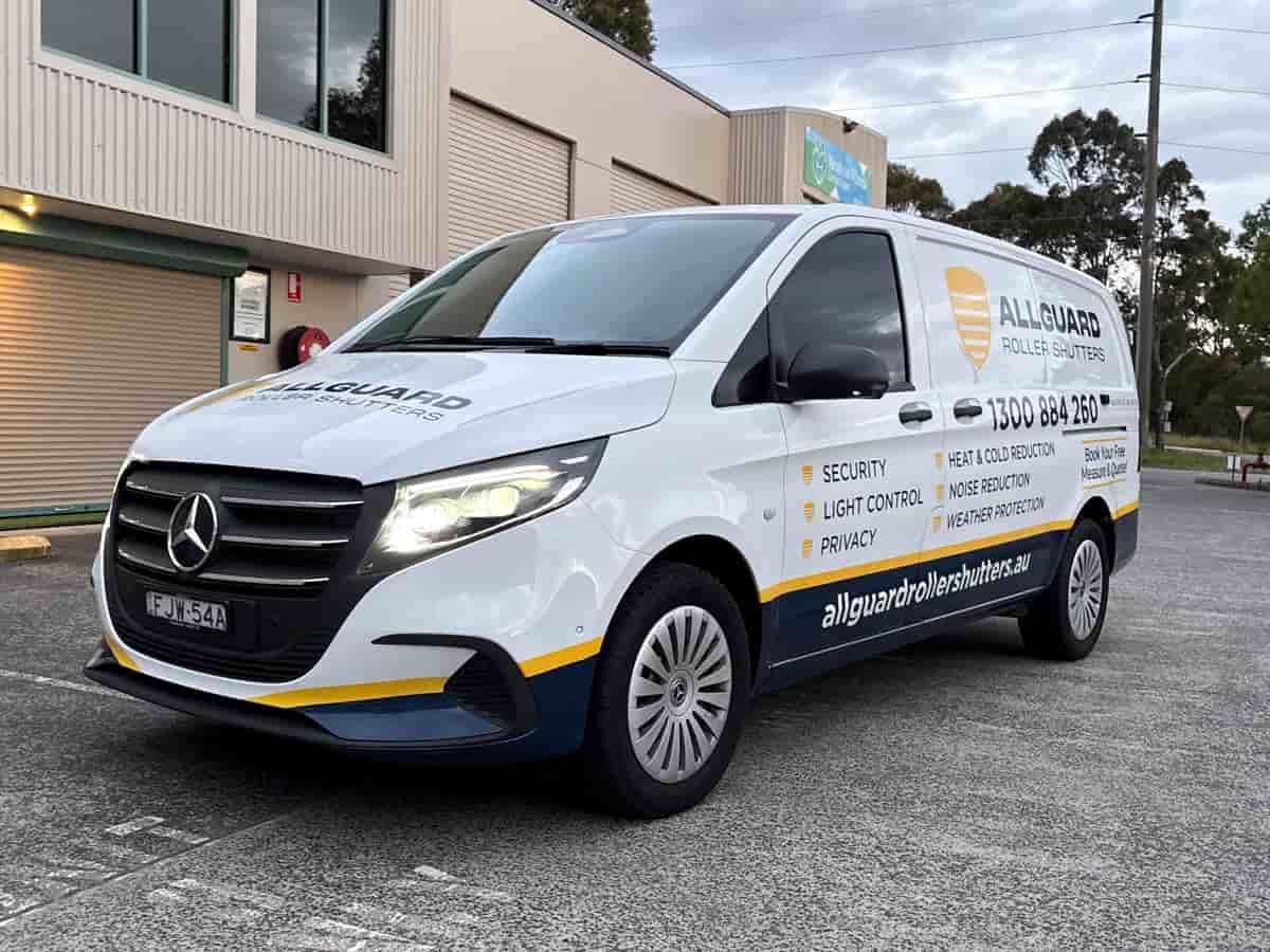 A White Van Is Parked In Front Of A Building — Solis Signs in Toukley, NSW