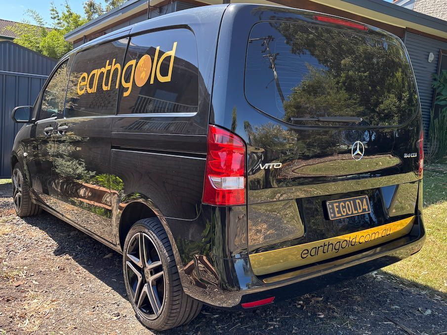 A Black Van Is Parked In Front Of A House — Solis Signs in Toukley, NSW