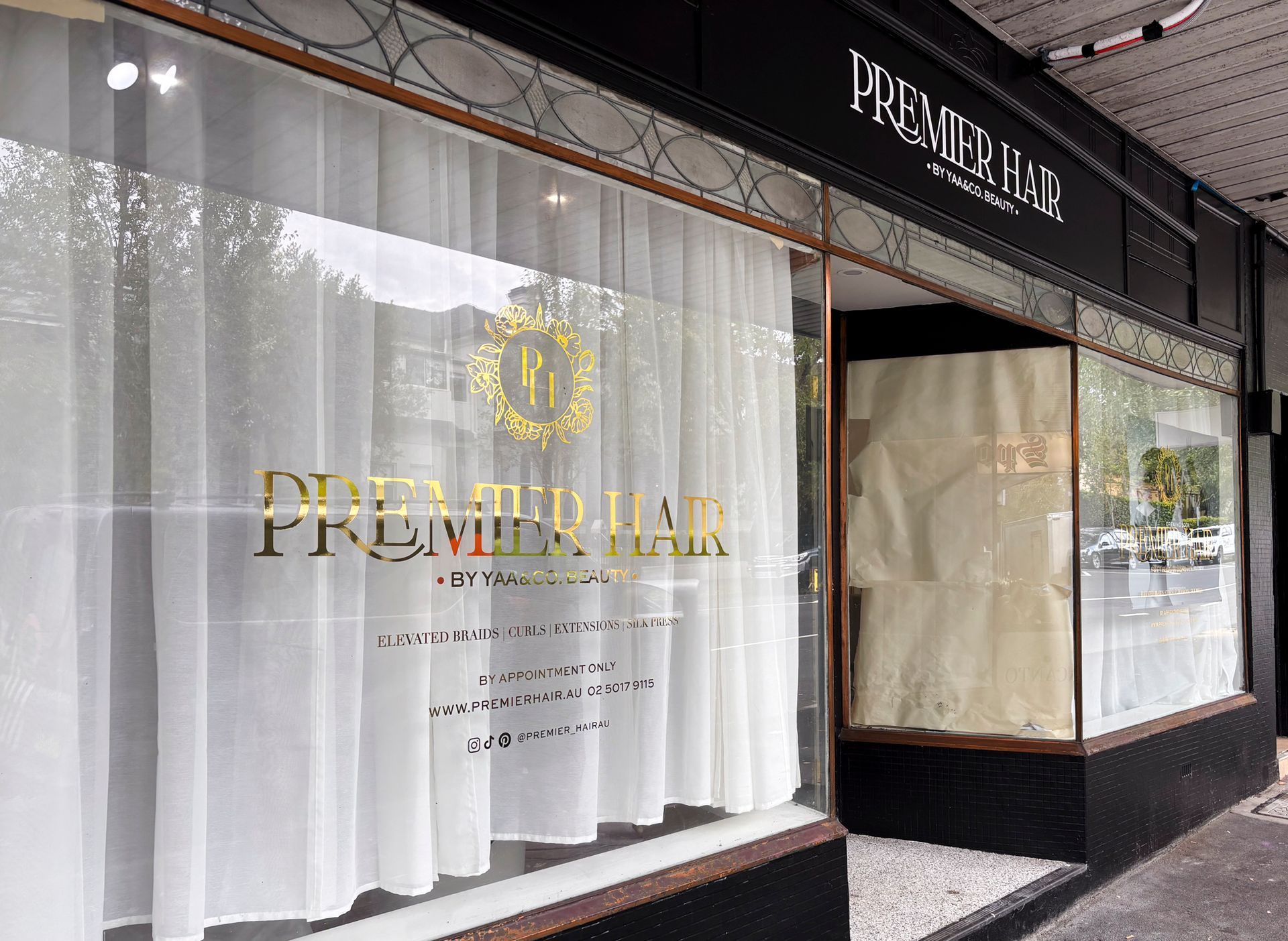 A store front with a sign that says premier on it — Solis Signs in Toukley, NSW