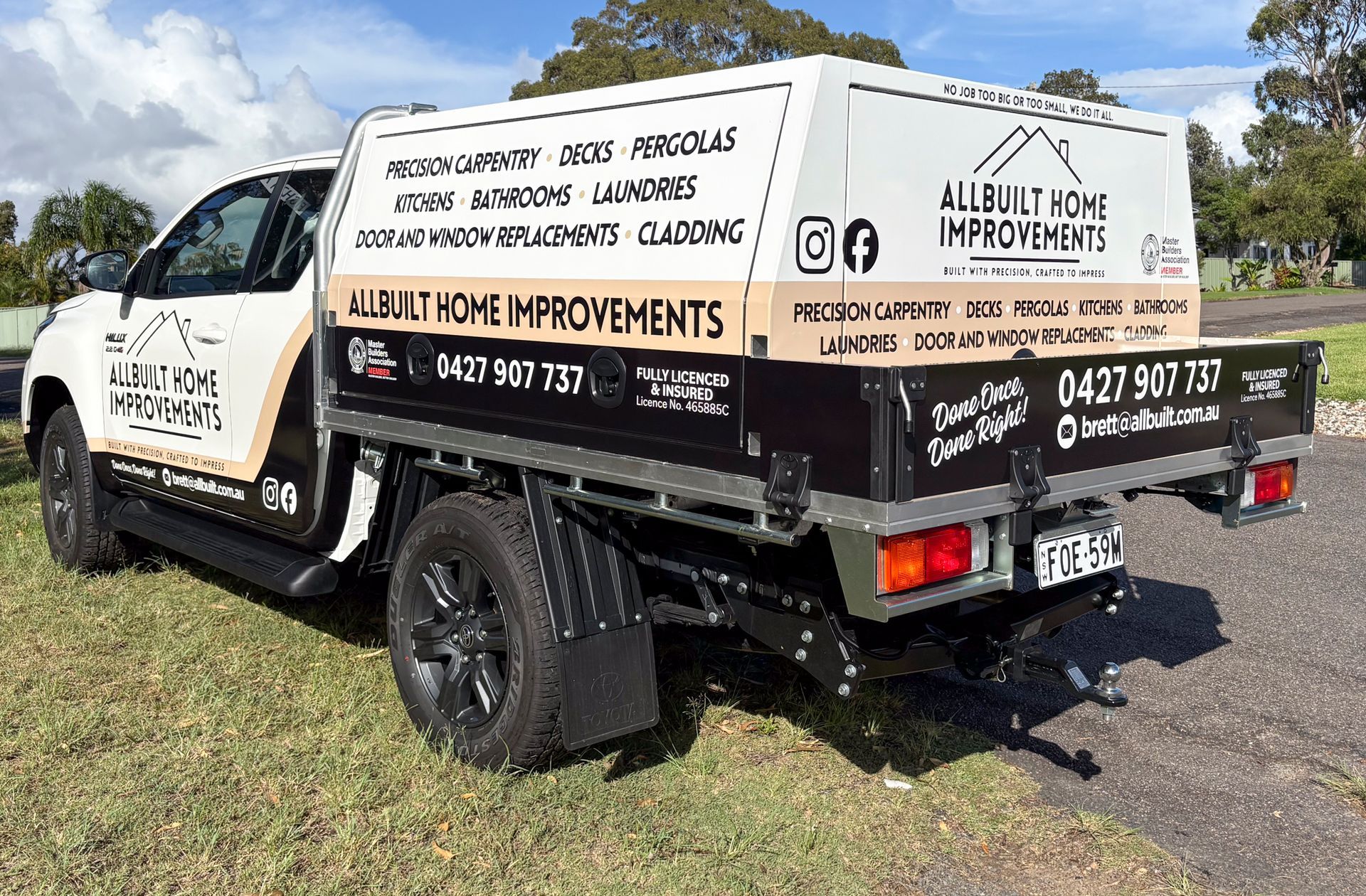 A White Truck With Solar Panels On The Side Is Parked On The Side Of The Road — Solis Signs in Toukley, NSW
