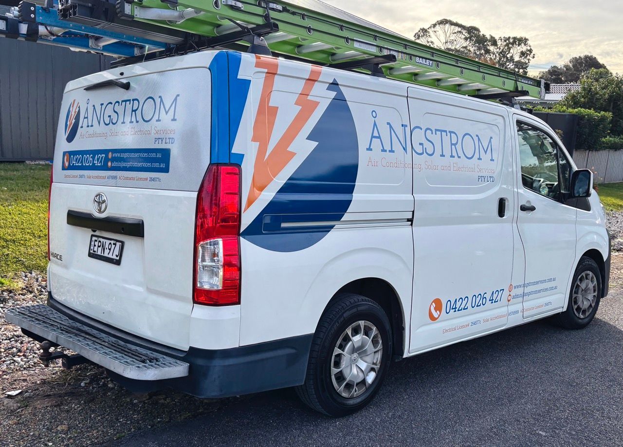 A White And Blue Van Is Parked In Front Of A House  — Solis Signs in Toukley, NSW