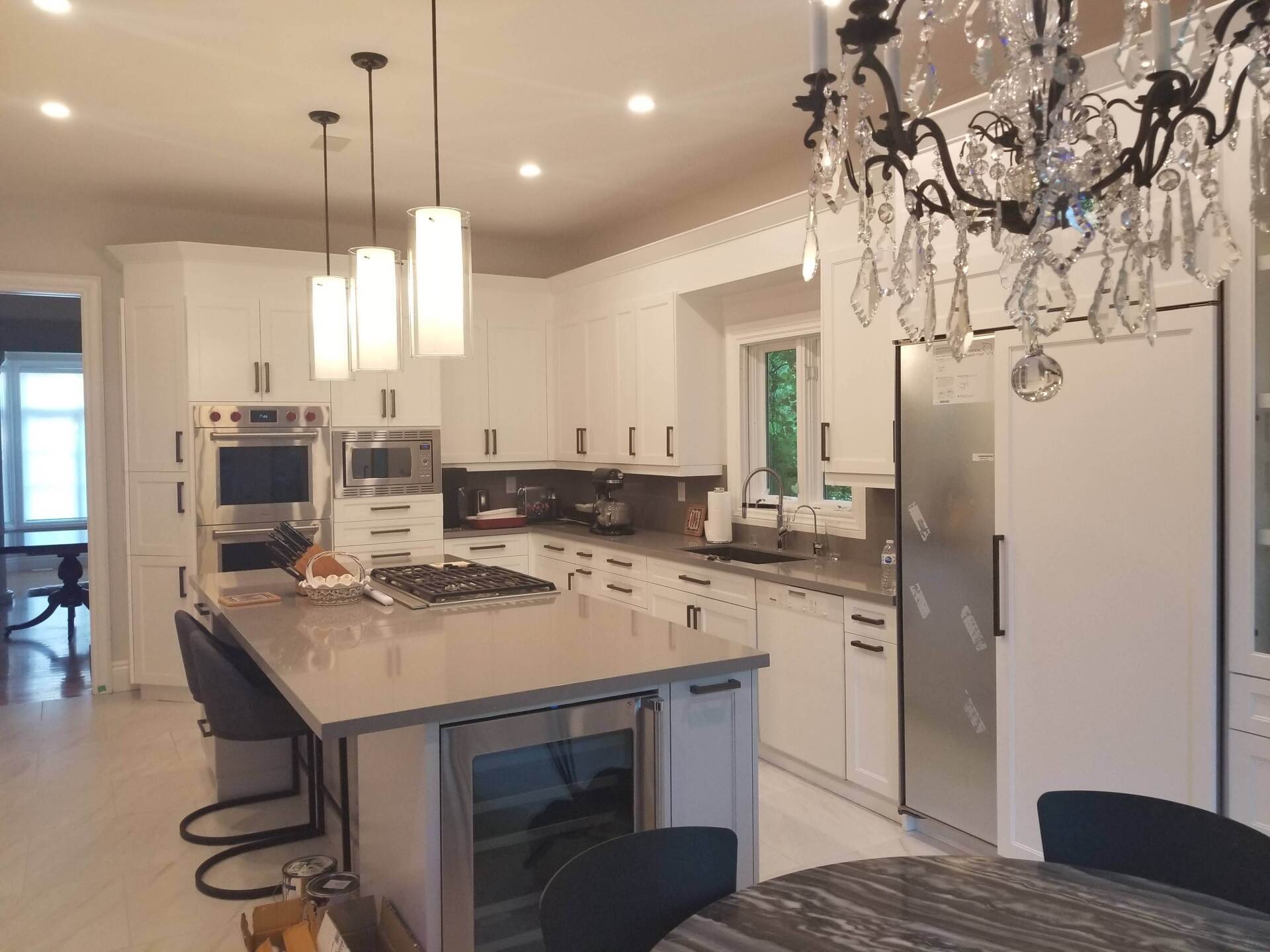 A kitchen with white cabinets and stainless steel appliances