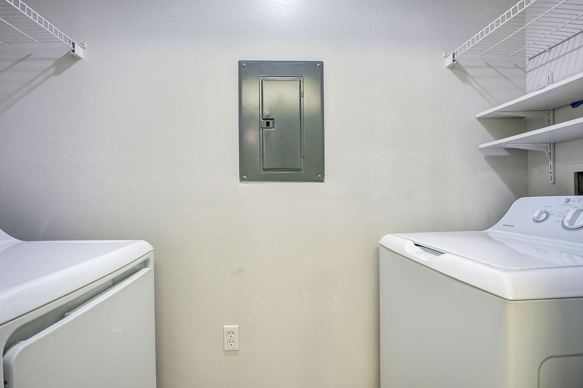 A laundry room with a washer and dryer in it.