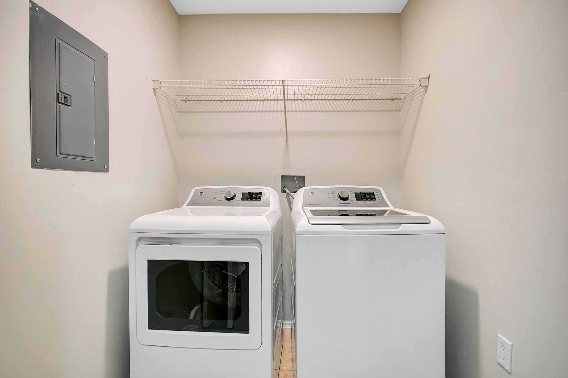 A laundry room with a washer and dryer in it.