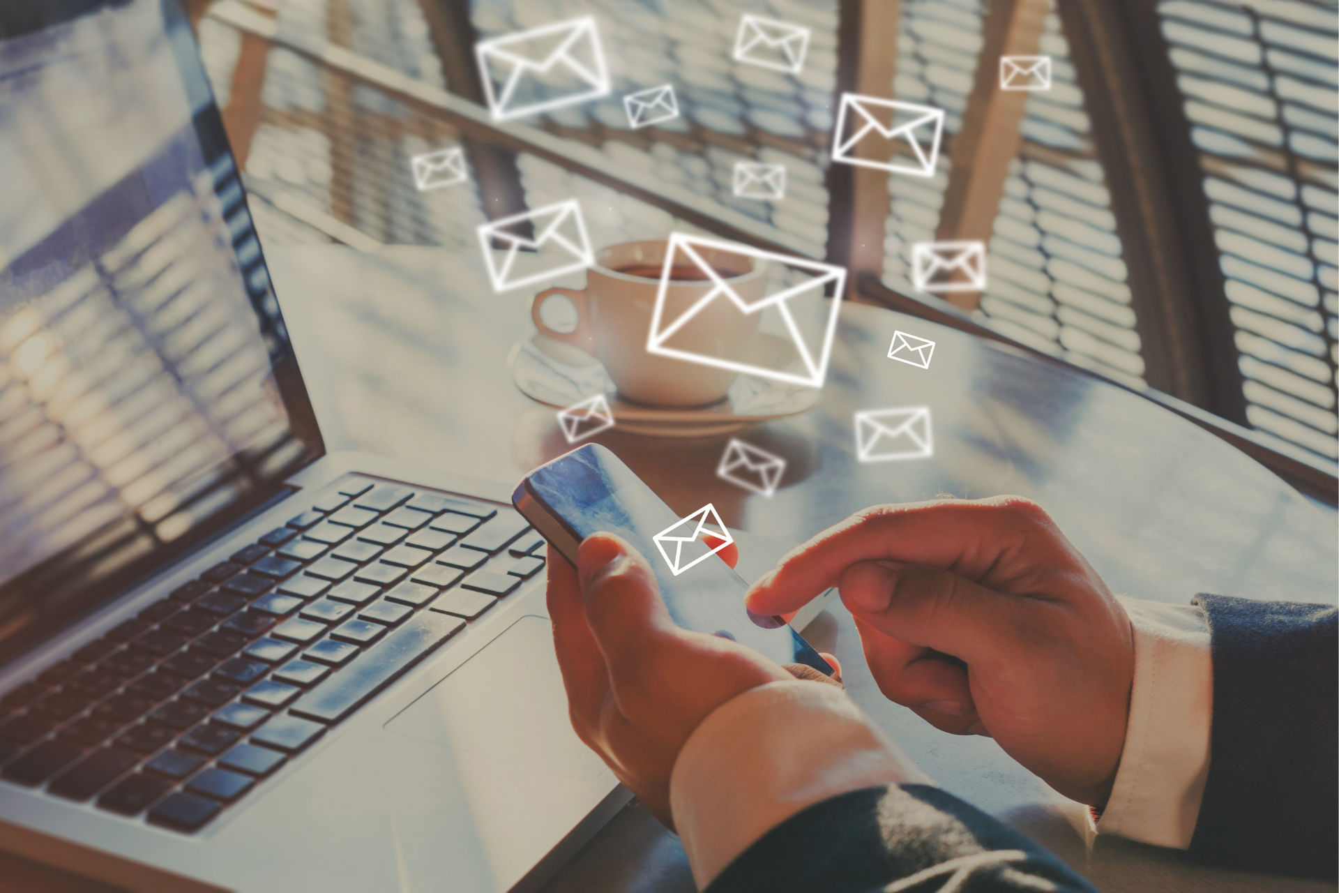 A person using a smartphone with floating email icons, symbolizing efficient email marketing and seamless communication across devices.