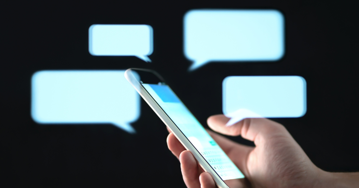 A person holds a smartphone with glowing message bubbles in the background, symbolizing live digital conversations.