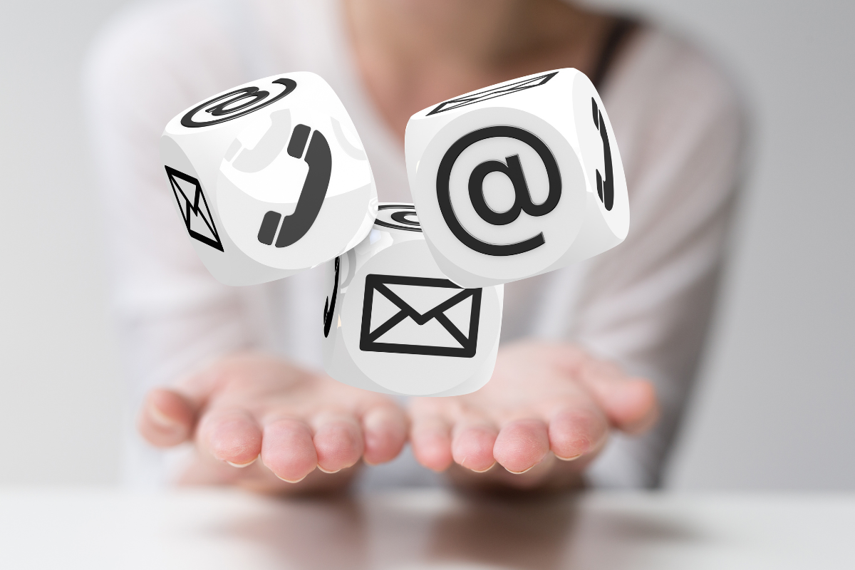 Hands holding contact icons on cubes, symbolizing multiple channels to connect with qualified leads.