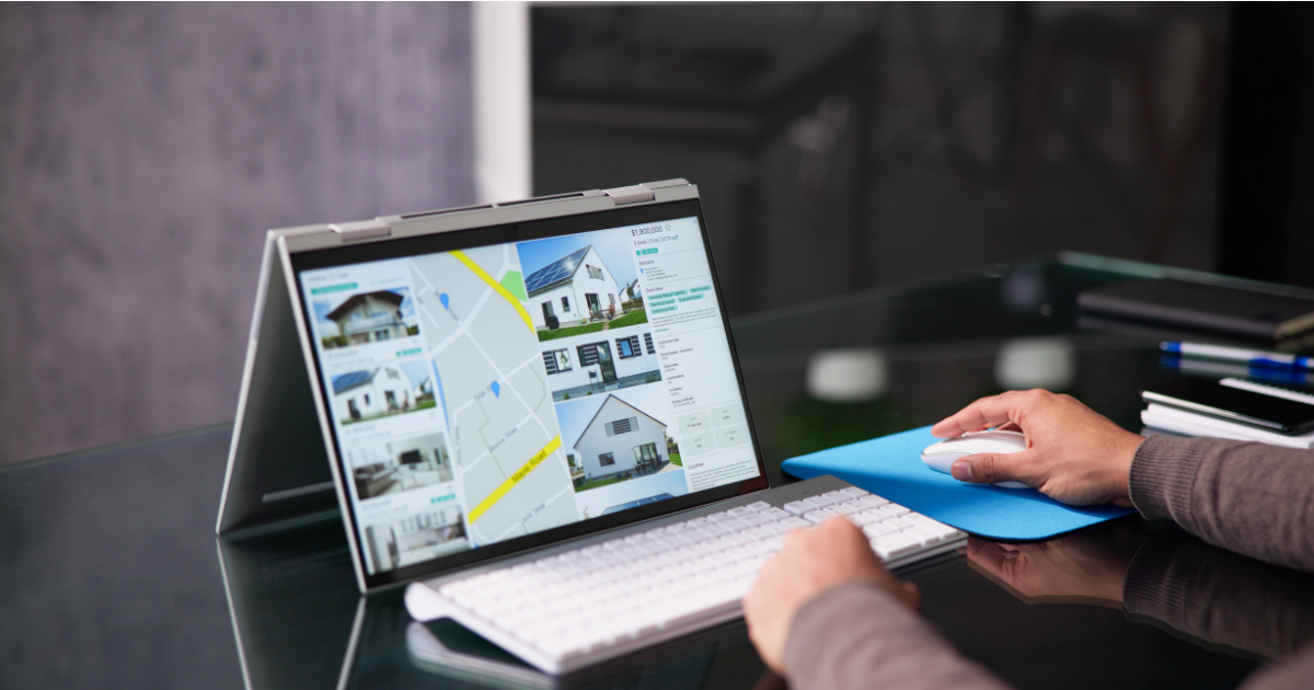 A person browsing real estate websites on a tablet displaying property listings and a map.