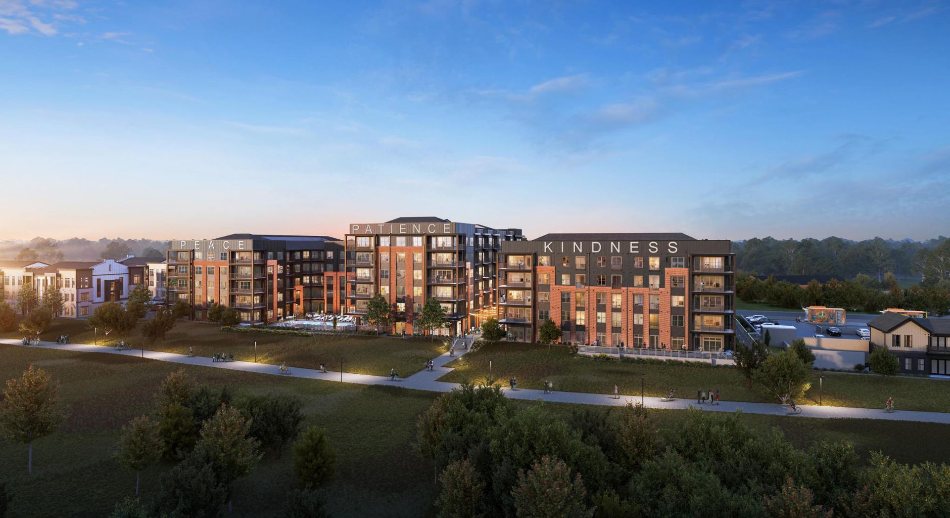 Modern apartment complex at dusk with lit windows, landscaped grounds, and a blue evening sky