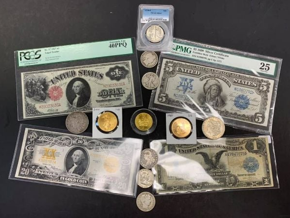 A group of coins and bills are sitting on top of each other on a table.